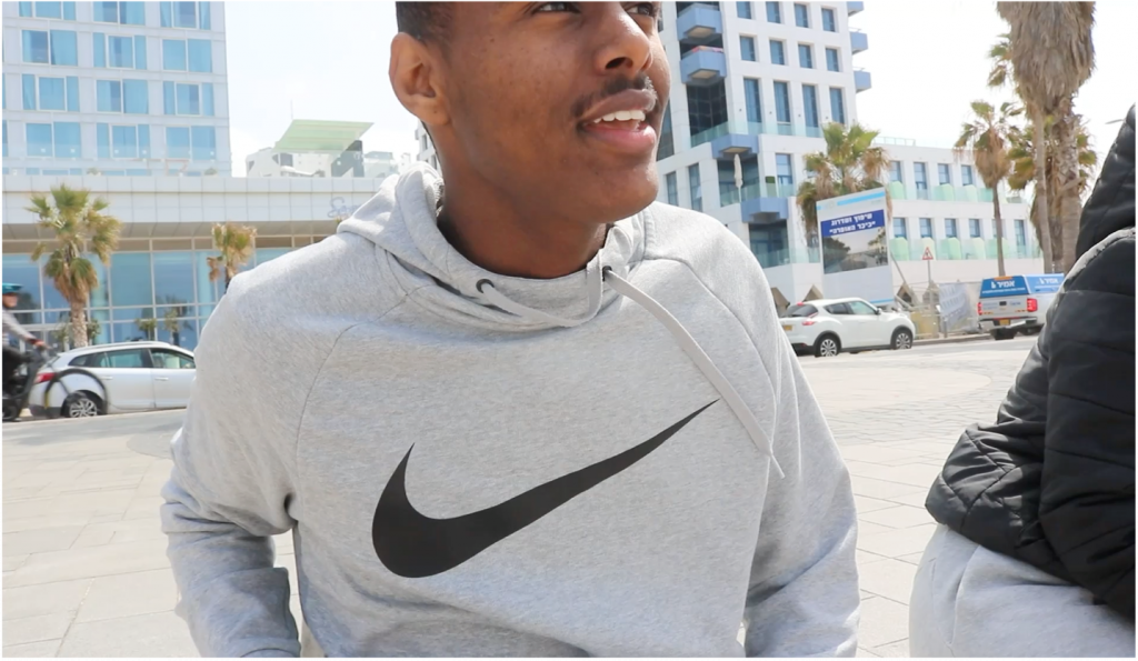 A young man in a Nike sweatshirt