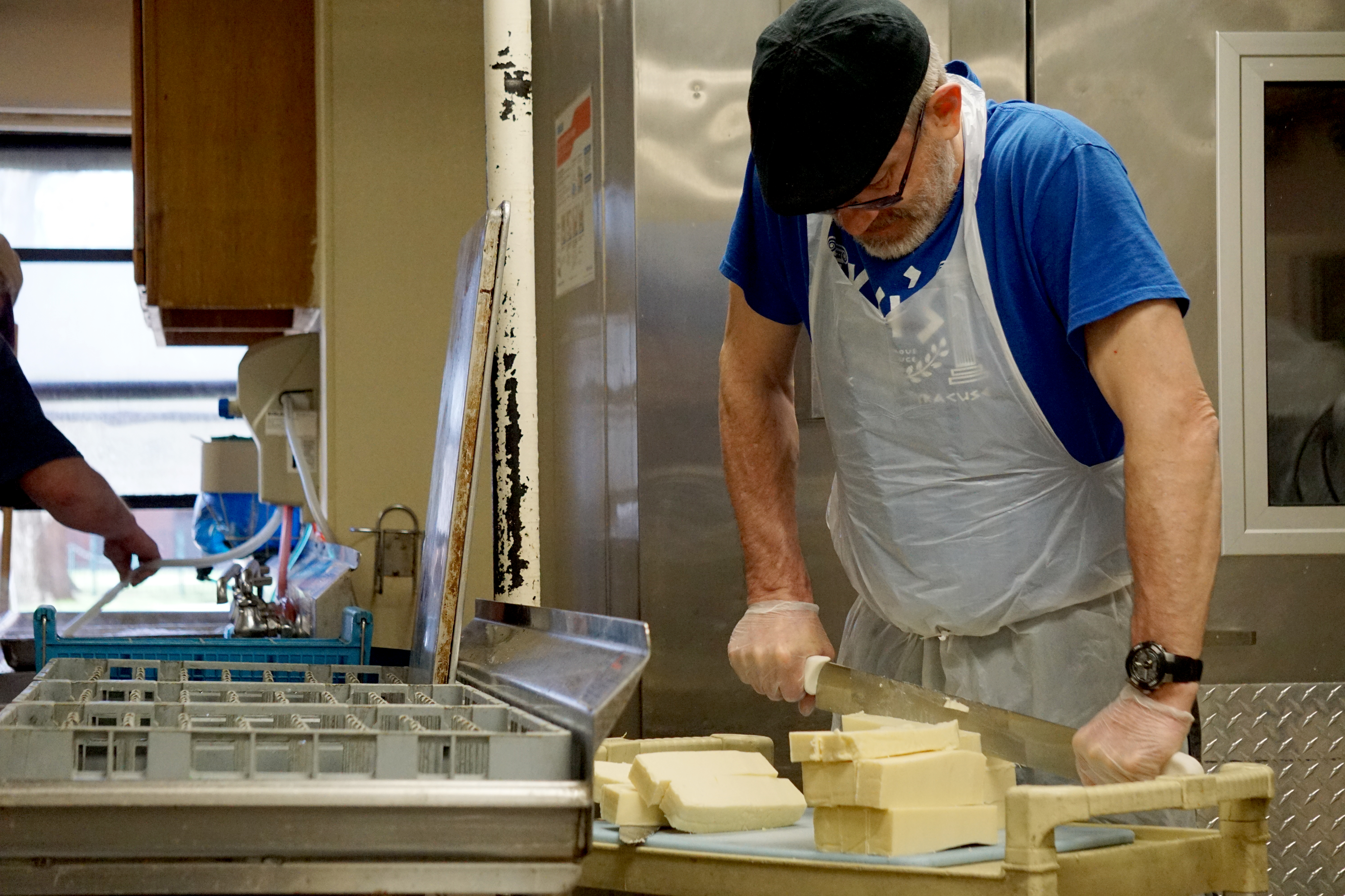 A volunteer portions out servings of cheese to be included in the meals delivered to the Meals on Wheels clientele. The organization services 33 routes across Onondaga County, including the city of Syracuse, Nedrow, the Onondaga Nation, Skaneateles, Jordan and Elbridge.