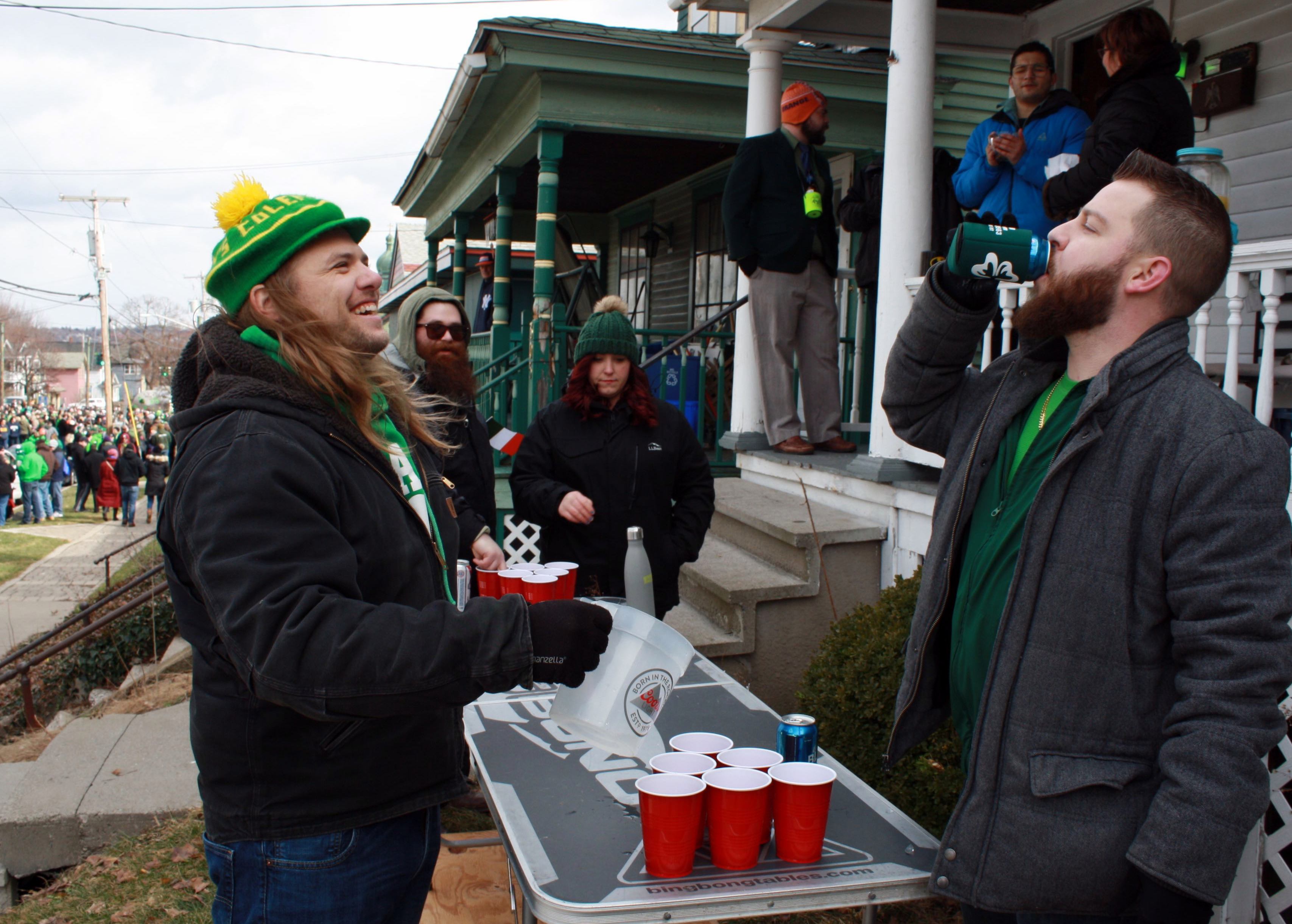Aaron Meile (left) lives on the same street where the parade occurs, making his house perfect for pregaming. He shares a laugh with friend Joe Viviano between rounds of beer pong. 